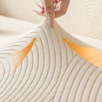 elasticite-housse-protection-canape-chat Zoom élasticité et résistance du tissu Housse Canapé Jacquard Spirale, flèches d'extension